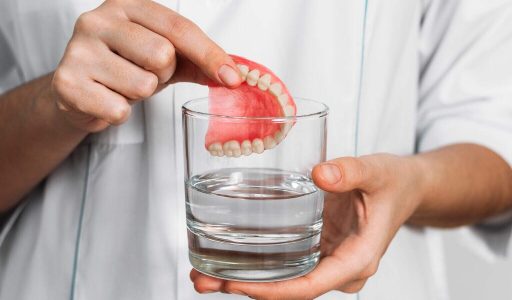 The,Prosthesis,Is,In,A,Glass,With,A,Solution.,Dental